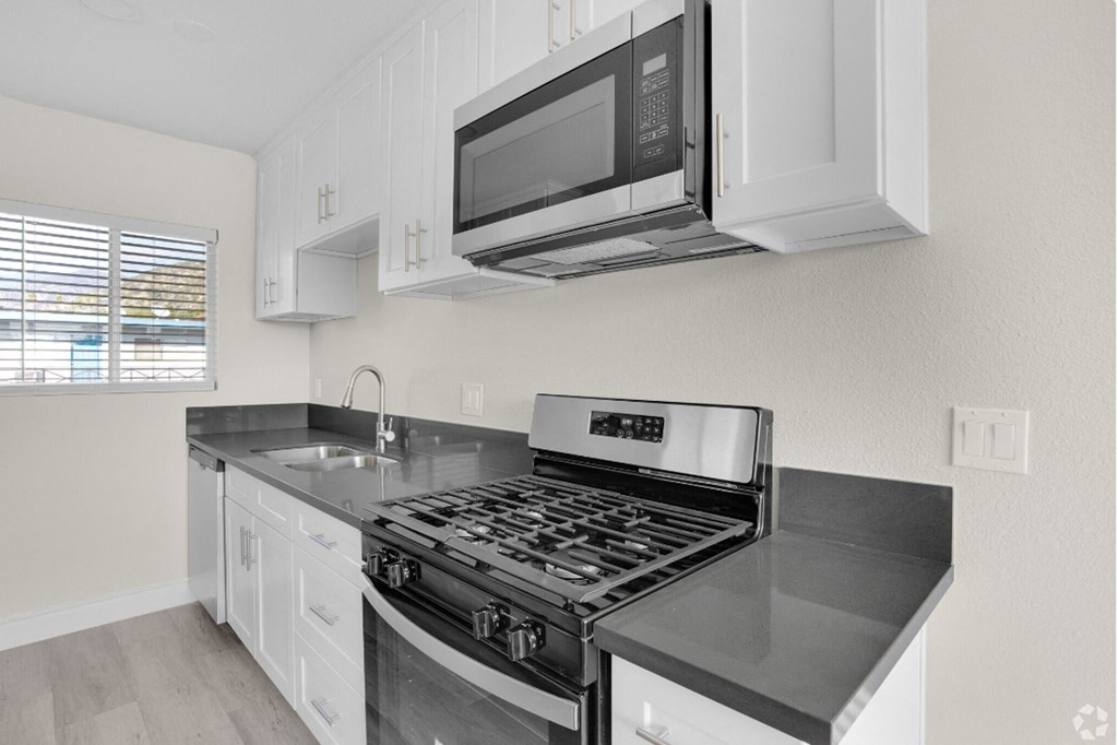 a kitchen with a stove and a microwave