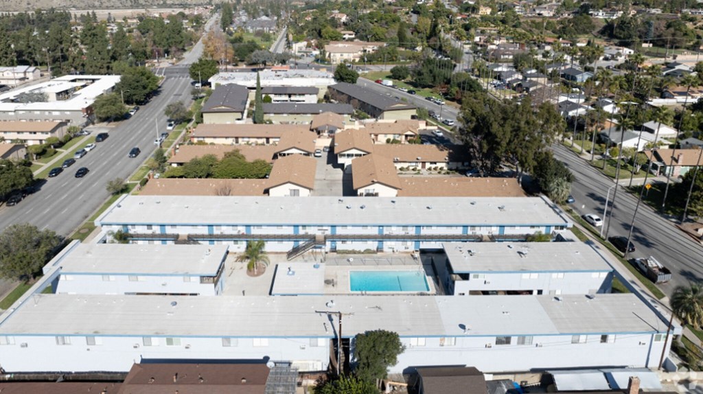 an aerial view of the roof of a building with a swimming pool