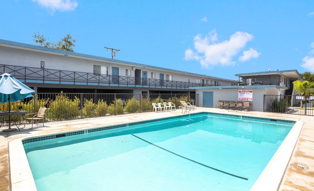 the pool is next to a building with a pool