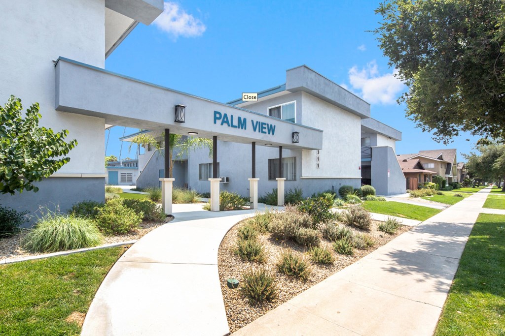 a white building with a sign that reads palm view llc