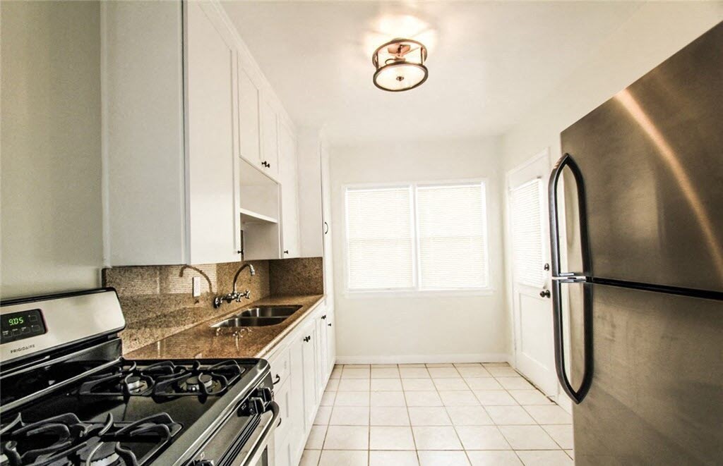 a kitchen with stainless steel appliances and white cabinets