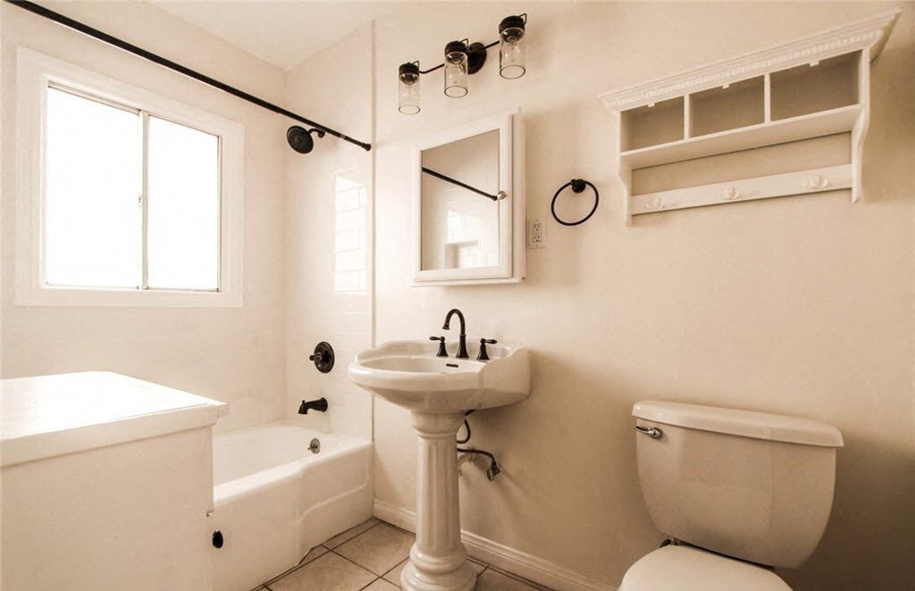 a bathroom with a sink toilet and a bath tub