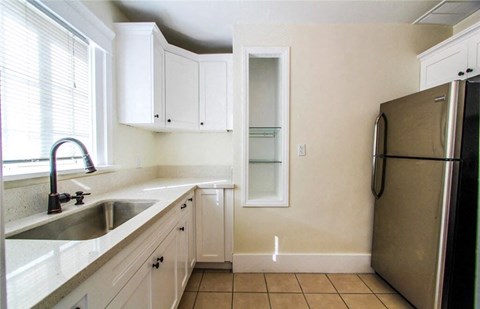 a kitchen with a sink and a refrigerator