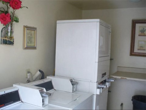 a small kitchen with a washing machine and a refrigerator