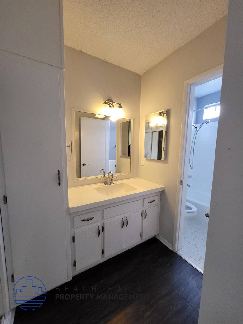 a bathroom with a sink and a shower and a mirror