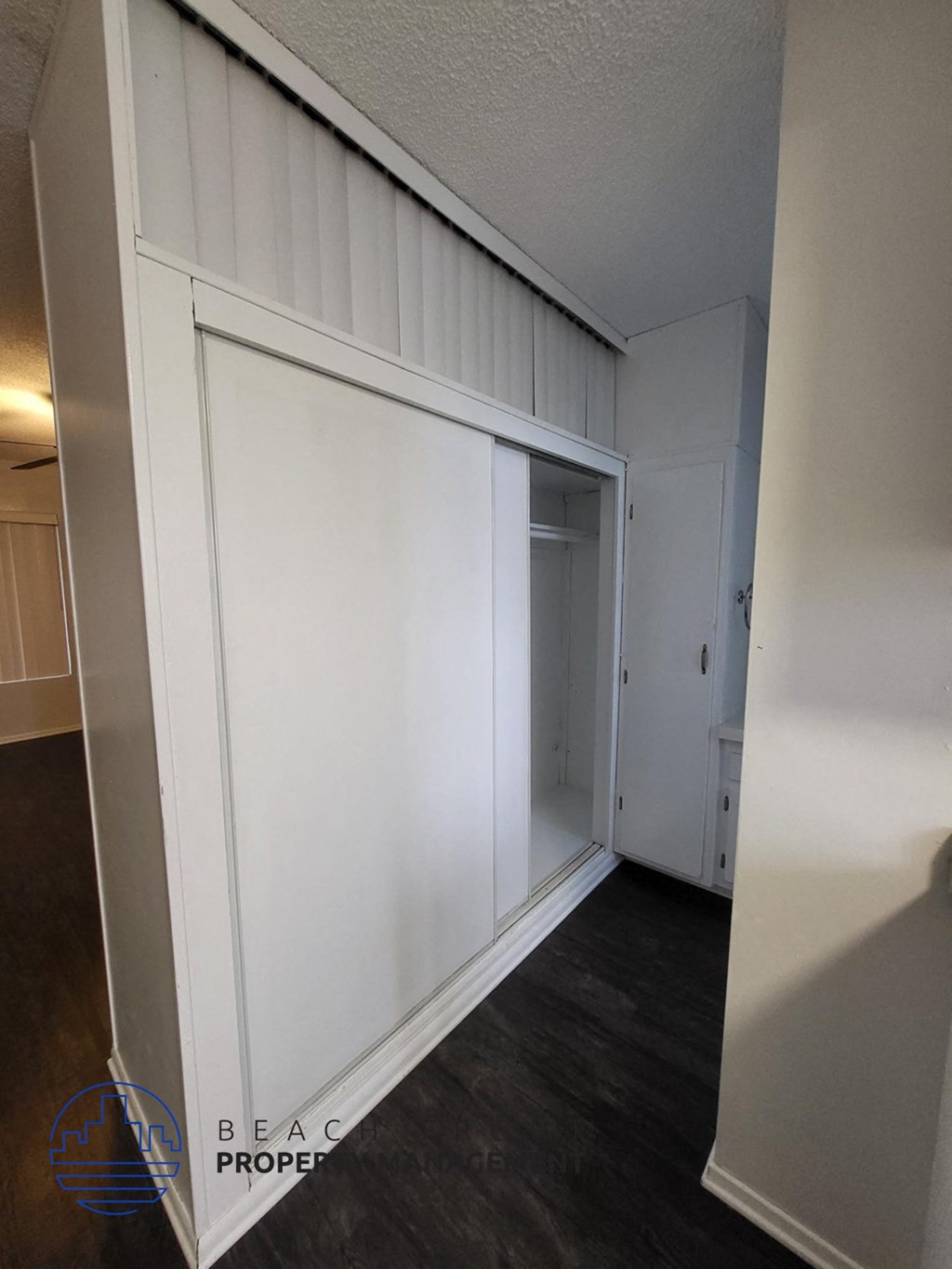 a white wall with a sliding door in a room