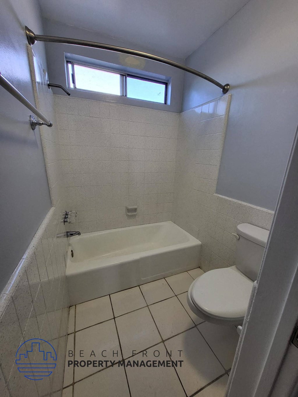 a small bathroom with a toilet and a bath tub