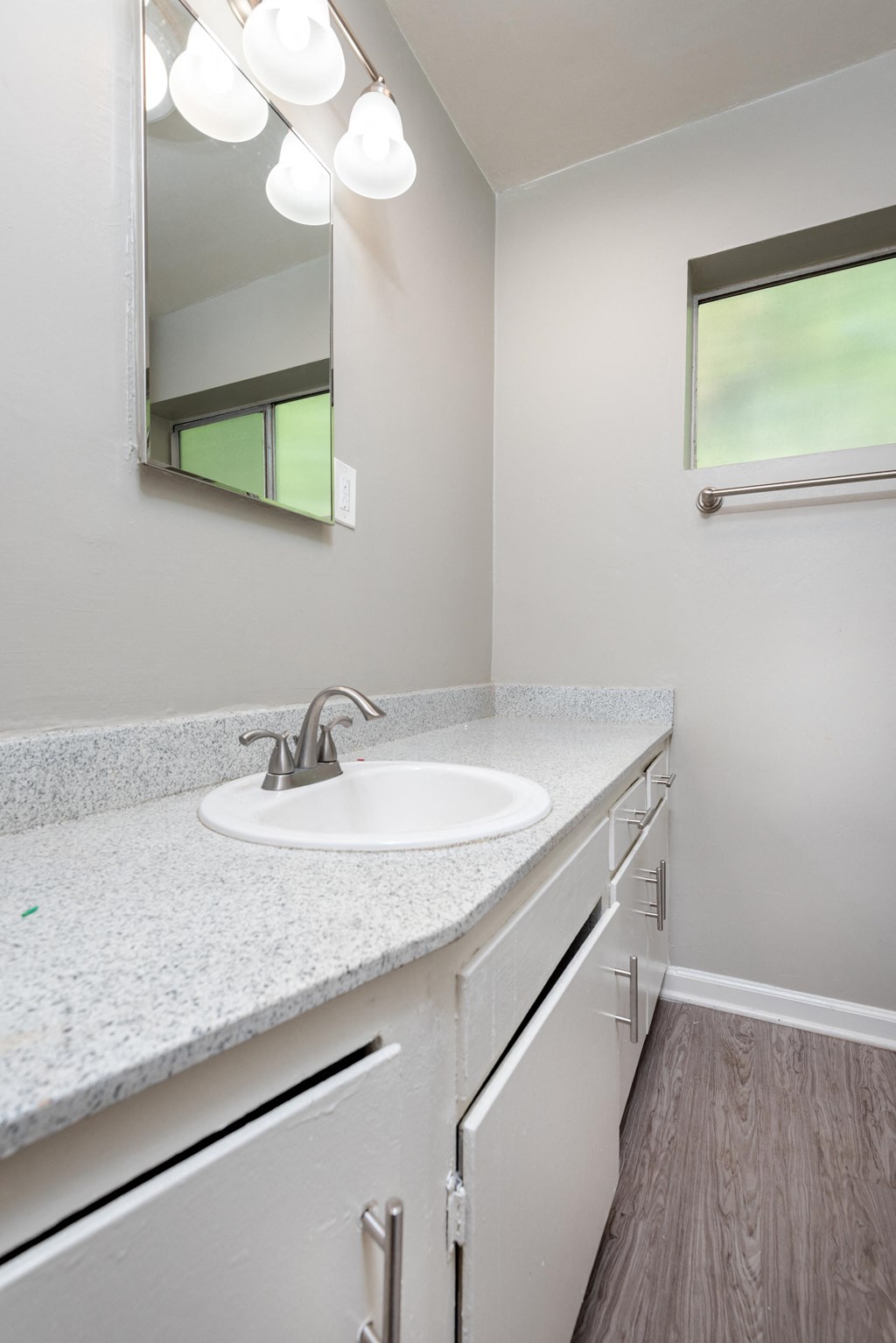an empty bathroom with a sink and a mirror