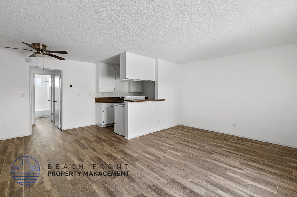 A room with wooden flooring and a ceiling fan.