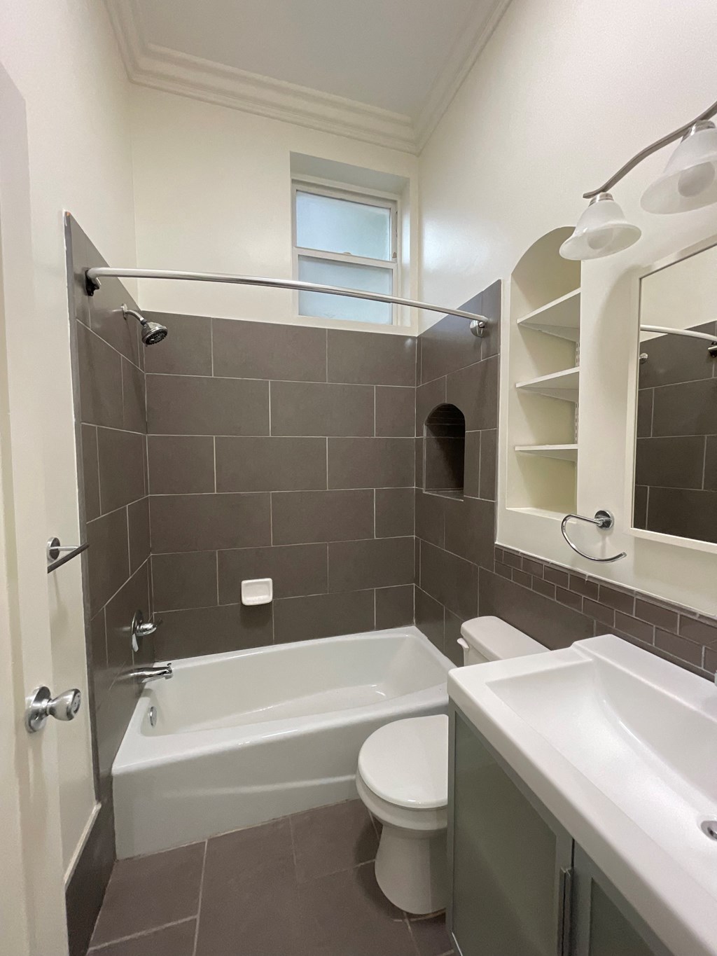a small bathroom with a shower toilet and sink