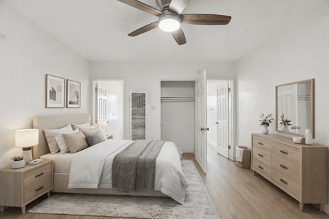 A bedroom with a bed, dresser, and mirror.