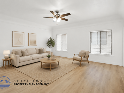 A living room with a couch, chair, and a ceiling fan.