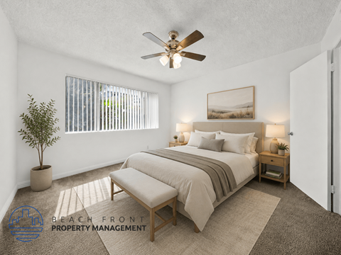 A bedroom with a bed, a bench, and a ceiling fan.