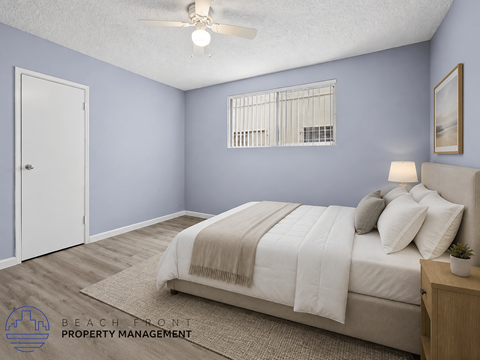 A bedroom with a bed, pillows, a ceiling fan, and a window with blinds.