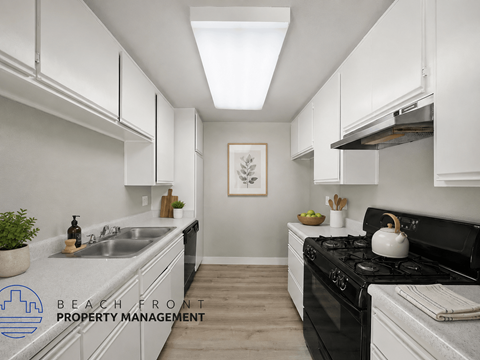 A kitchen with a stove top oven and a sink.