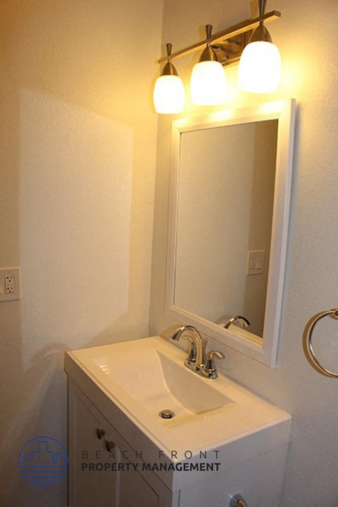 a bathroom with a white sink and a mirror