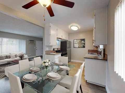 A modern dining room with a glass table set for four.