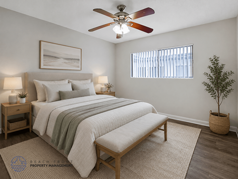 A bedroom with a bed, a bench, a ceiling fan, and a potted plant.