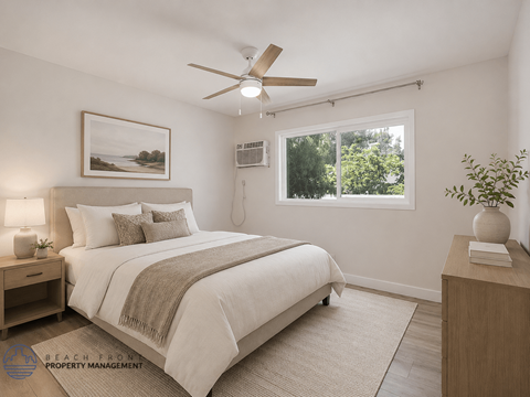 A bedroom with a bed, nightstand, and a painting on the wall.