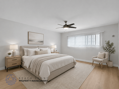 A well-lit bedroom with a large bed, a chair, and a ceiling fan.