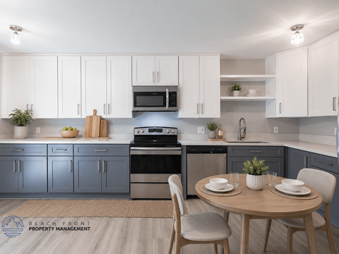 A modern kitchen with a dining table set for two.