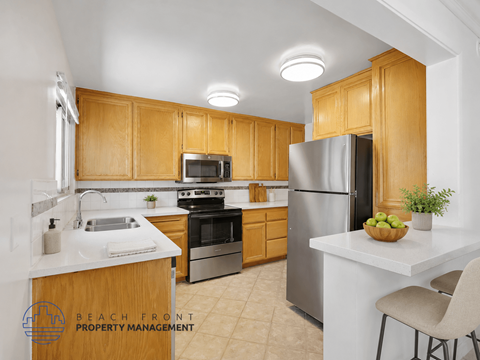 A kitchen with wooden cabinets and stainless steel appliances.
