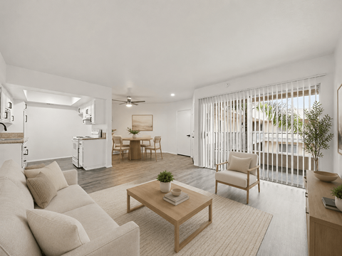 A living room with a white couch and a wooden coffee table.