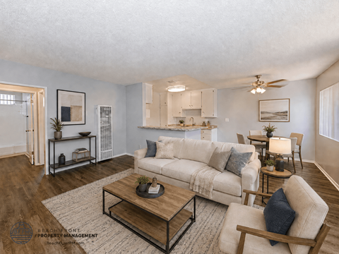 A living room with a white couch and a coffee table.