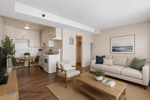 A living room with a couch, chairs, and a coffee table.