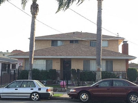 a house with two cars parked in front of it