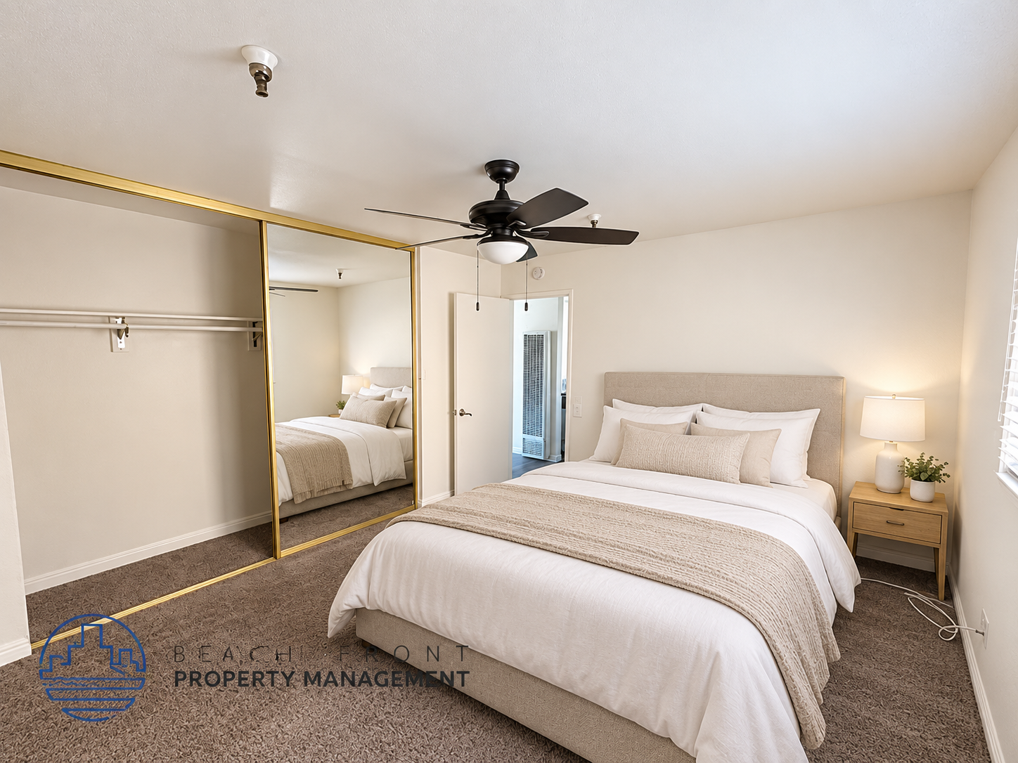 A bedroom with a large bed and a ceiling fan.
