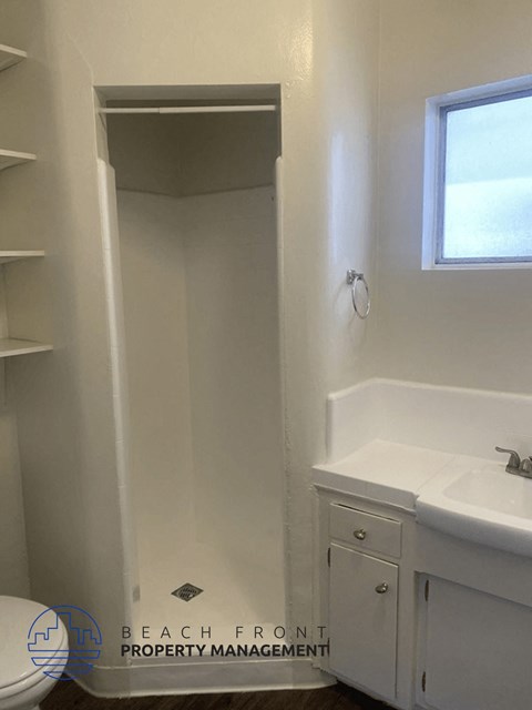a bathroom with a sink and a toilet and a shower