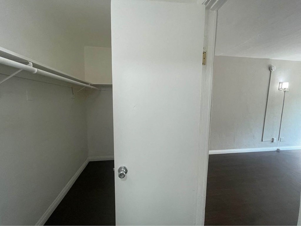 an empty room with a white wall and a door