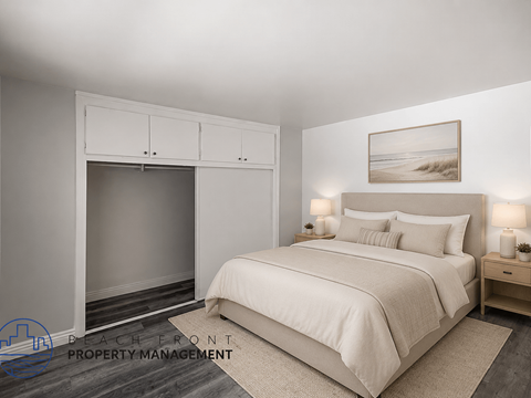 A bedroom with a large bed, a fireplace, and a painting on the wall.