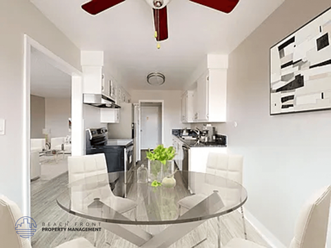 A modern kitchen with a glass table and white chairs.