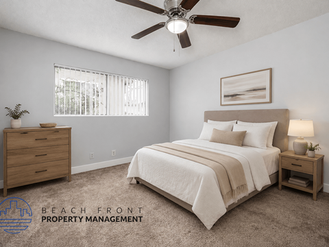 A bedroom with a bed, nightstand, and a ceiling fan.
