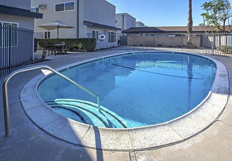 A small round pool with a metal railing around it.