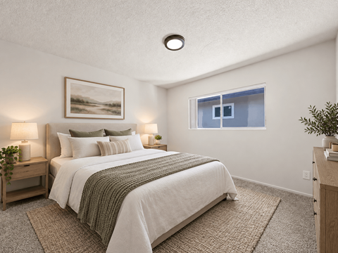 A bedroom with a large bed and a painting on the wall.