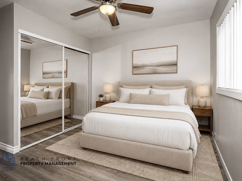 A bedroom with a large bed and a ceiling fan.