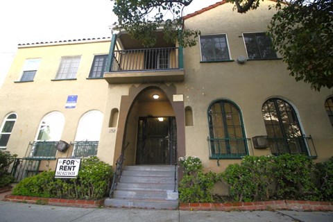 a house with afor rent sign in front of it