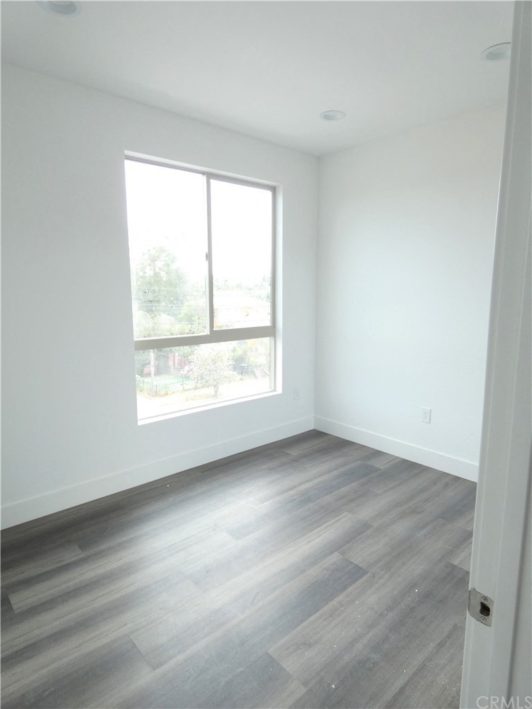 an empty room with white walls and a window