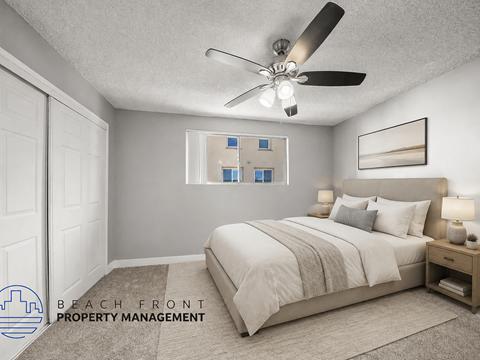 A bedroom with a bed, nightstand, and a ceiling fan.