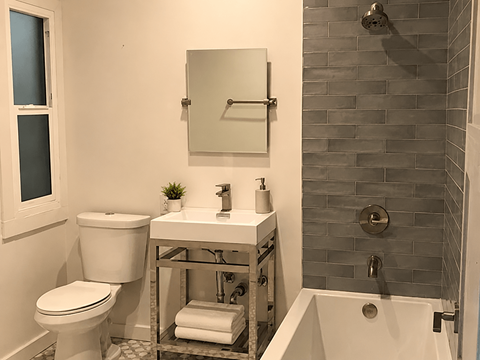 A white toilet sits next to a sink in a bathroom.