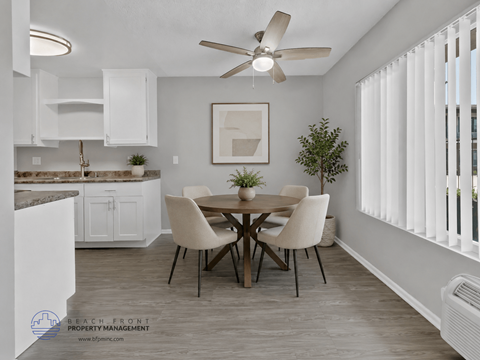 A dining room with a table set for four.