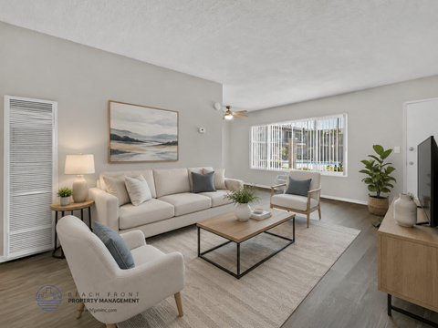 A well-lit living room with a large painting on the wall and a comfortable seating area.