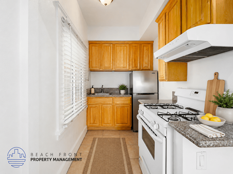 A kitchen with wooden cabinets and white appliances.
