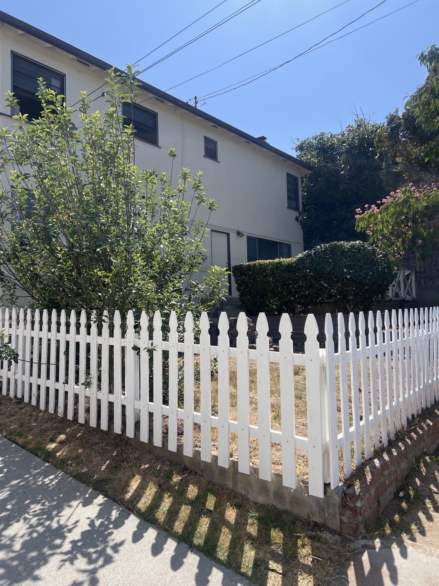 a white picket fence in front of a house