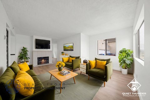 A living room with a fireplace, two couches, and a coffee table.