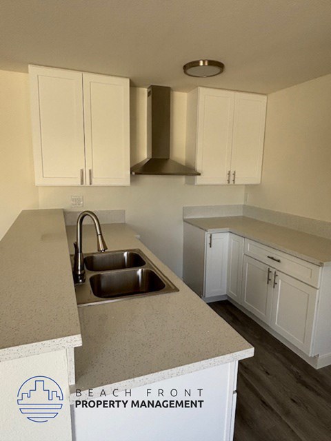 A kitchen with a sink and cabinets.