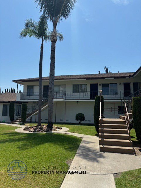 a large white house with palm trees in front of it